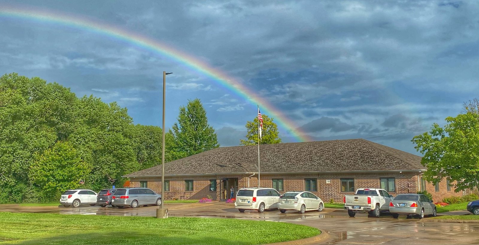 Outside Harvest Baptist Church in Manhattan, KS with a rainbow in the sky