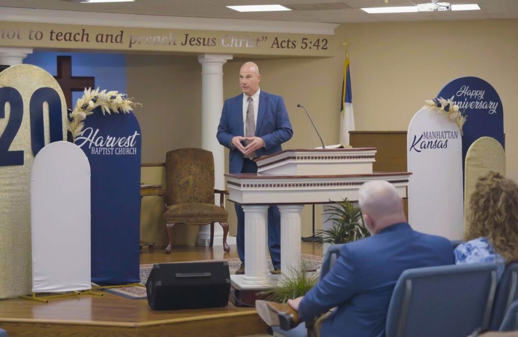 Pastor Chris McCurry preaching from the pulpit of Harvest Baptist Church in Manhattan, KS